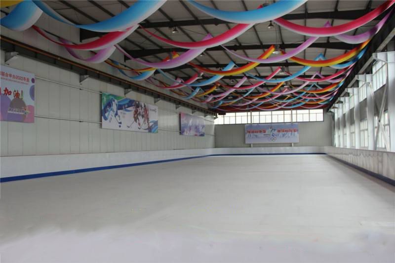 Synthetic ice skating rink system